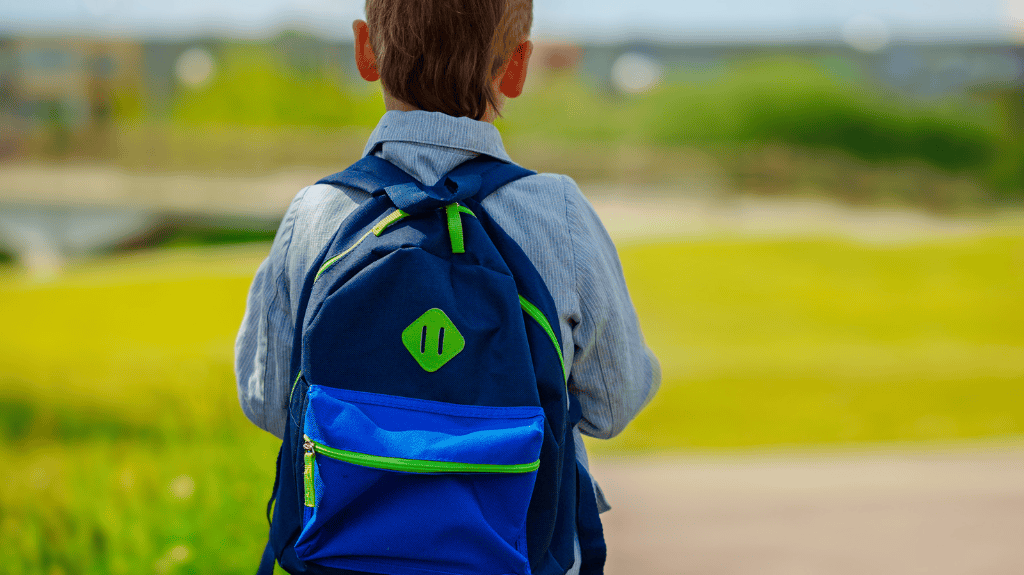 nervous kindergarten with backpack going to school