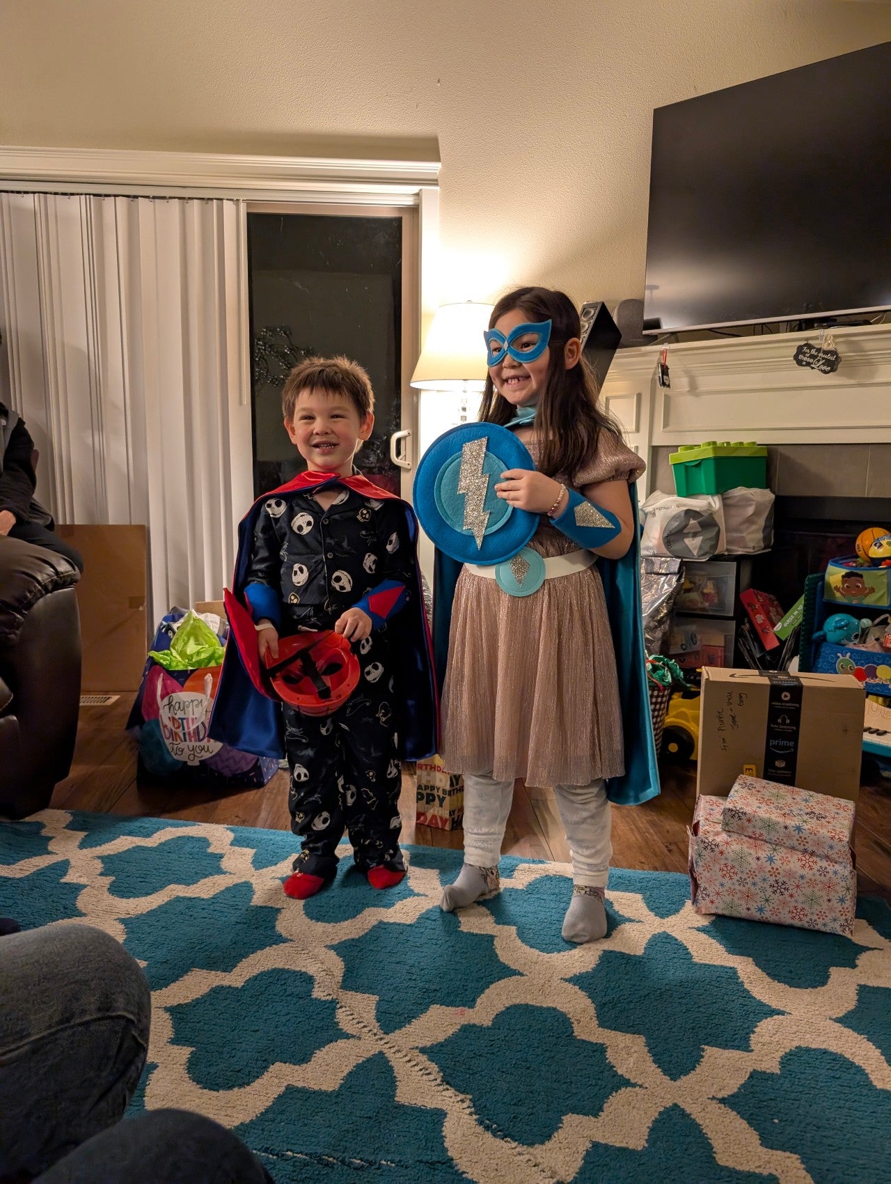 Proud kids in living room surrounded by holiday gifts,  Their faces show that Creative Capes was the best gift