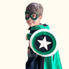 boy in positive affirmation green and black personalized superhero costume set,  dress-up costume kit - lined satin cape, shield, mask, belt, and wrist cuffs. Handmade by Creative Capes in USA to inspire imaginative play and confidence, activity for healthy childhood.