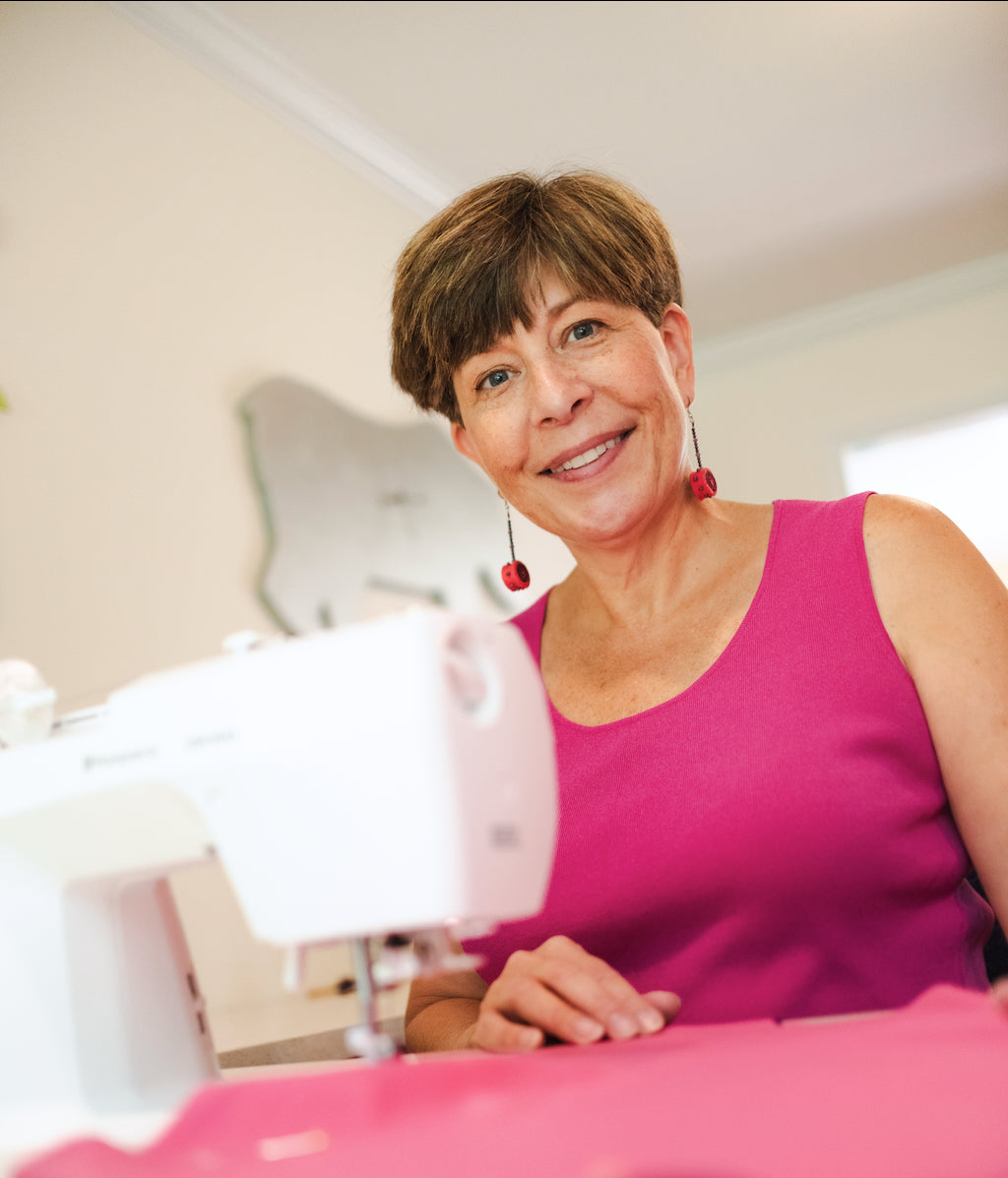 Holly Hagen at sewing machine making Creative Capes superhero costumes for kids ages 3 to 8 years old