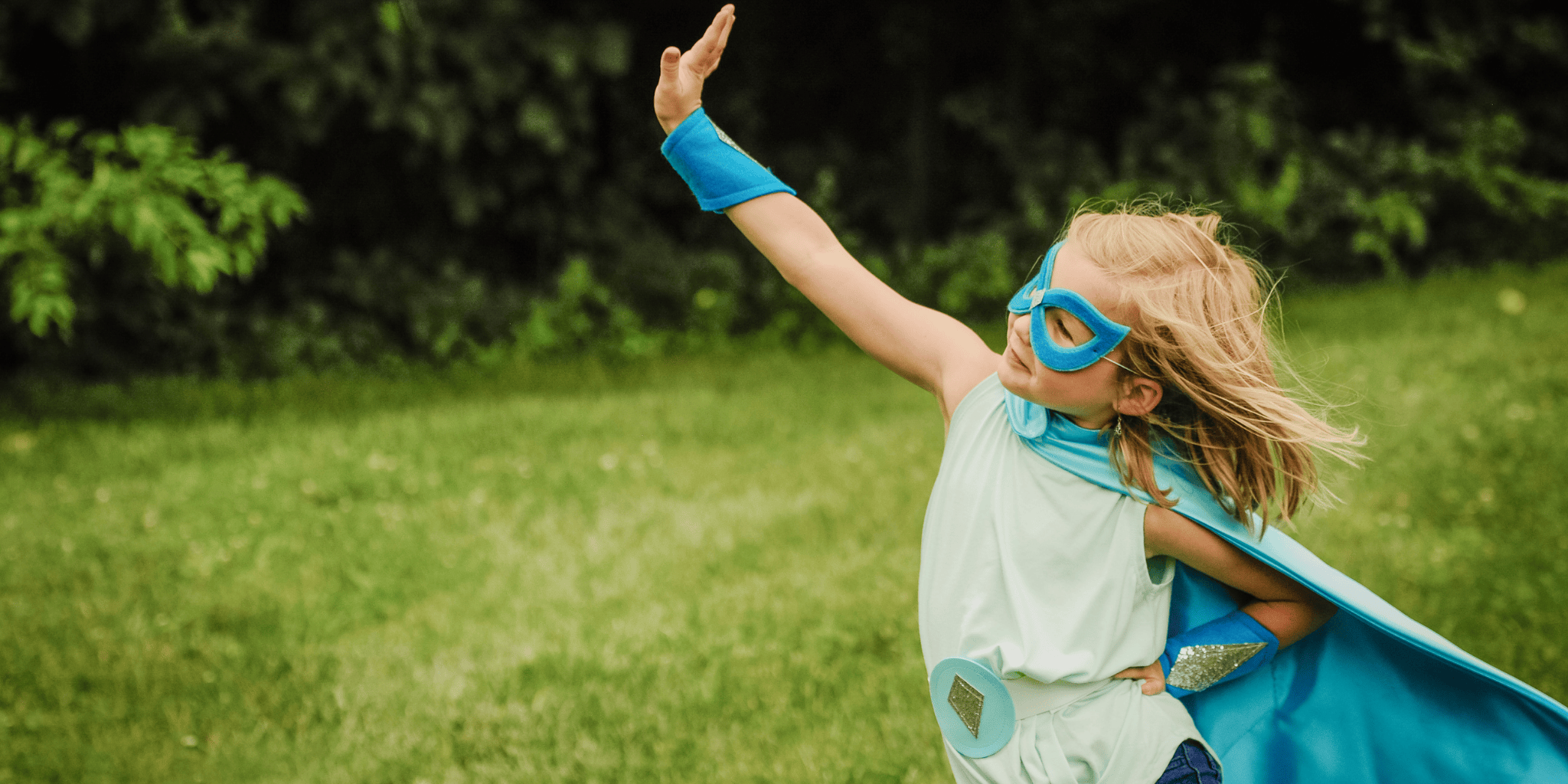5 year old girl having pretend play in her blue and silver superhero dress-up costume, creative play for frozen fans, superhero outfit includes handmade cape, mask, arm bands, and hero belt to encourage creative thinking and positive self image. Open-ended play by Creative Capes