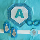 sparkle blue cape set by Creative Capes. The costume includes mask, belt, wrist cuffs and personalized cape with silver