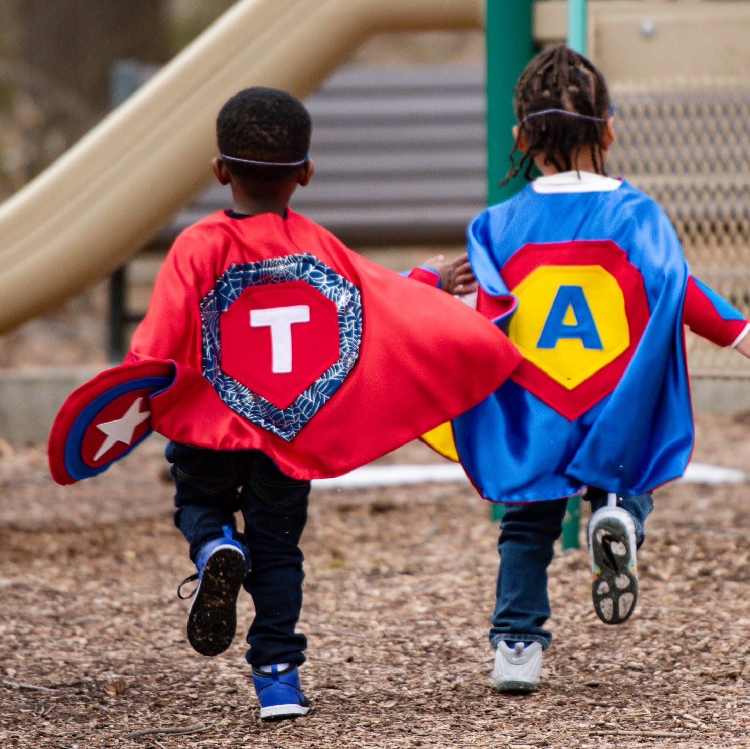 Boys Running outdoors in quality made personalized superhero costumes, capes inspired by superman and spiderman, Creative Capes makes each child into their own super hero