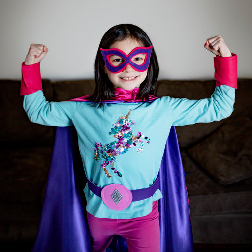 girl in purple and pink personalized superhero costume set, creative play activity, ages 3 to 8 years old, quality dress-up costume kit - satin cape, shield, mask, belt, and wrist cuffs, handmade by Creative Capes in USA, toy to inspire imaginative play and confidence, activity for imaginations, no screens for a healthy childhood