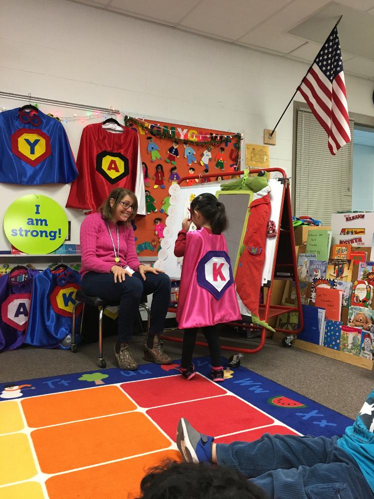 teacher and preschooler discussing the students super powers thanks to Creative Capes