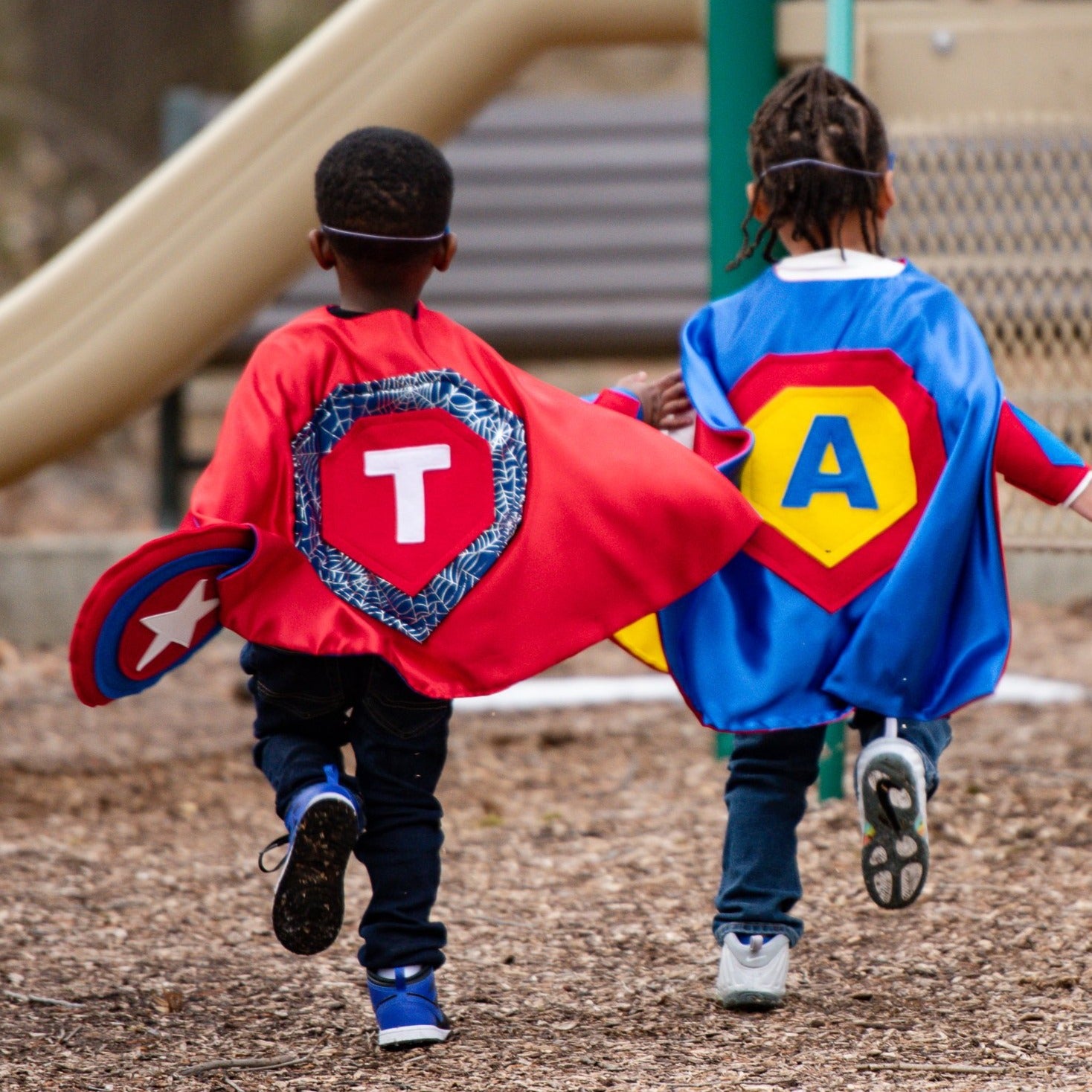 Boys Running outdoors in quality made personalized superhero costumes, capes inspired by superman and spiderman, Creative Capes makes each child into their own super hero
